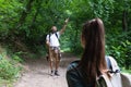 Young happy couple and their dog at hiking through the woods enjoying the sight. Two nature lovers in the mountain forest enjoy Royalty Free Stock Photo