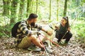 Young happy couple and their dog at hiking through the woods enjoying the sight. Two nature lovers in the mountain forest enjoy Royalty Free Stock Photo