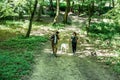 Young happy couple and their dog at hiking through the woods enjoying the sight. Two nature lovers in the mountain forest enjoy Royalty Free Stock Photo