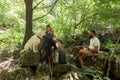 Young happy couple and their dog at hiking through the woods enjoying the sight. Two nature lovers in the mountain forest enjoy Royalty Free Stock Photo