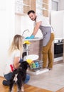 Happy couple unloading dishwasher Royalty Free Stock Photo