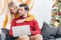 young happy couple using laptop at home Royalty Free Stock Photo