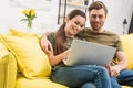 young happy couple using laptop together Royalty Free Stock Photo