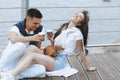 Young happy couple on walk with small dog on sea promenade Royalty Free Stock Photo