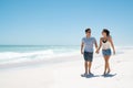 Young happy couple walking on beach Royalty Free Stock Photo