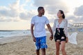 Young happy couple walking on the beach holding hands. Royalty Free Stock Photo