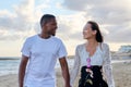 Young happy couple walking on the beach holding hands. Royalty Free Stock Photo