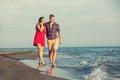 Young happy couple walking on beach Royalty Free Stock Photo