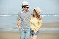 young happy couple walking on beach smiling holding each other Royalty Free Stock Photo