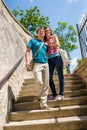 Young happy couple walking down stairs smiling