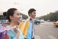 Young happy couple walking down the street with colorful shopping bags in Beijing Royalty Free Stock Photo