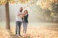 Young happy couple walking and having fun in autumn park Royalty Free Stock Photo