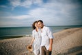 Young happy couple walking in the morning by the sea beach Royalty Free Stock Photo