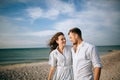 Young happy couple walking in the morning by the sea beach Royalty Free Stock Photo