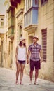 Young couple walking in old street in Valletta, Malta