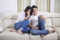 Young happy couple watching television at home Royalty Free Stock Photo