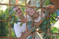 Young happy couple at wooden lattice