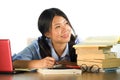 Young happy and cute Asian Chinese teenager student smiling happy working and studying with texbooks and laptop computer sitting Royalty Free Stock Photo