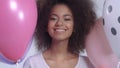 Young happy cute woman with balloons smiling, close up.