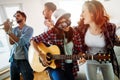 Young happy dancing girls playing guitar and partying Royalty Free Stock Photo