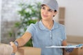 young happy deliverywoman shaking hands with client Royalty Free Stock Photo