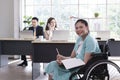 Young happy disabled Businesswoman on Wheelchair in modern office Royalty Free Stock Photo