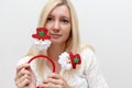 Young happy emotional caucasian woman with christmas decorative santa claus accessories for the head on white background Royalty Free Stock Photo