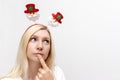 Young happy emotional caucasian woman with christmas decorative santa claus accessories for the head on white background with copy Royalty Free Stock Photo