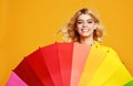 Young happy emotional cheerful girl laughing with colorful umbrella on colored yellow background