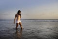 Young happy and excited Asian woman having fun enjoying playful and free at sunset beach in tourism vacation Royalty Free Stock Photo