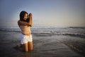 Young happy and excited Asian woman having fun enjoying playful and free at sunset beach in tourism vacation Royalty Free Stock Photo