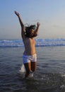 Young happy and excited Asian woman having fun enjoying playful and free at sunset beach in tourism vacation Royalty Free Stock Photo