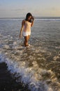 Young happy and excited Asian woman having fun enjoying playful and free at sunset beach in tourism vacation Royalty Free Stock Photo