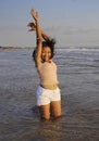 Young happy and excited Asian woman having fun enjoying playful and free at sunset beach in tourism vacation Royalty Free Stock Photo