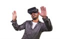 Young happy and excited man wearing virtual reality VR goggles headset experimenting 3d illusion playing video game touching Royalty Free Stock Photo