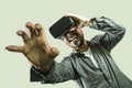 Young happy and excited man wearing virtual reality VR goggles headset experimenting 3d illusion playing video game touching Royalty Free Stock Photo