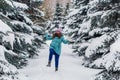 Young happy excited woman in in spruce forest, winter happy portrait, holiday Royalty Free Stock Photo