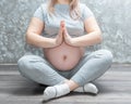 Young happy expectant relaxing, thinking about her baby and enjoying her future life. Yoga classes at home Royalty Free Stock Photo