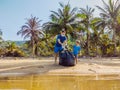 Young happy family activists collecting plastic waste on beach. Dad and son volunteers clean up garbage. Environmental Royalty Free Stock Photo