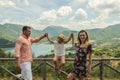 Young happy family on a background of a mountain lake Lago del Turano