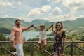 Young happy family on a background of a mountain lake Lago del Turano