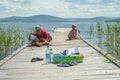 A young happy family with a child is resting near the lake. Royalty Free Stock Photo