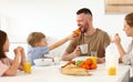 Young happy family eating morning breakfast together at home Royalty Free Stock Photo