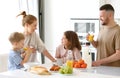 Young happy family eating morning breakfast together at home Royalty Free Stock Photo