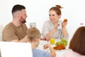 Young happy family eating morning breakfast together at home Royalty Free Stock Photo