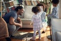 A young happy family is enjoying making soap bubbles while playing at home together. Family, home, together, playtime Royalty Free Stock Photo