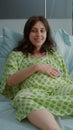 Young happy family expecting childbirth in hospital ward