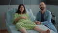 Young happy family expecting childbirth in hospital ward Royalty Free Stock Photo