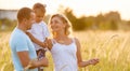 Young happy family in a field