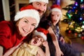 Young happy family of four taking a photo of themselves on Christmas Royalty Free Stock Photo
